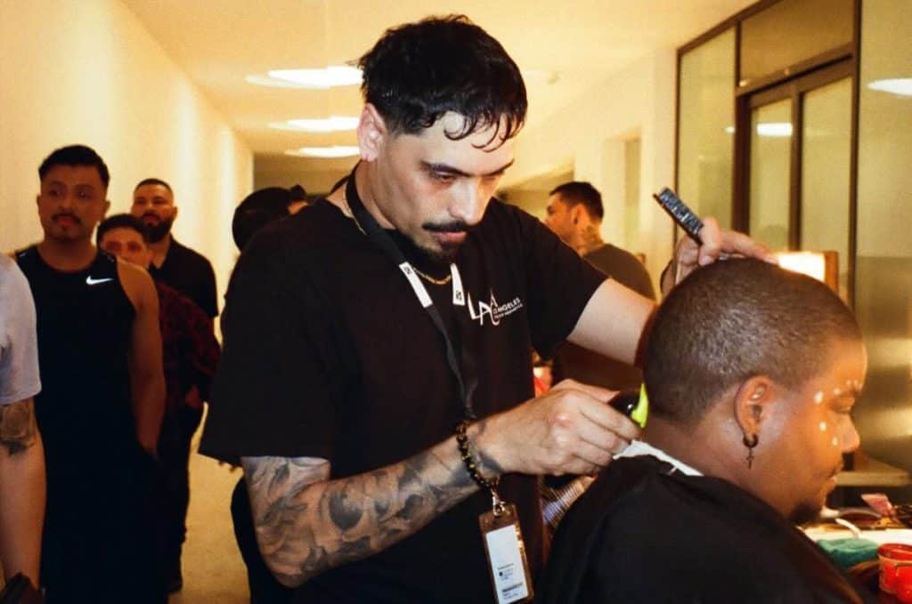 Student shaving a client's head