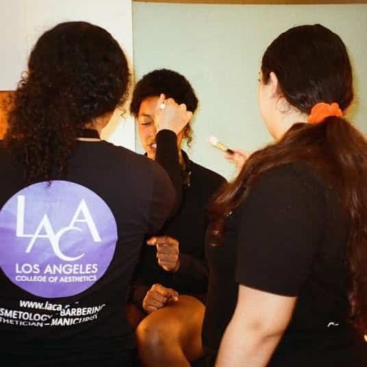 Students applying makeup on someone