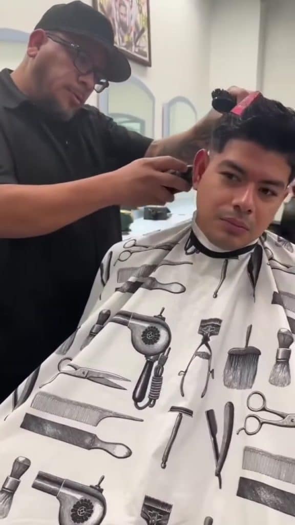 Barber student cutting someone's hair