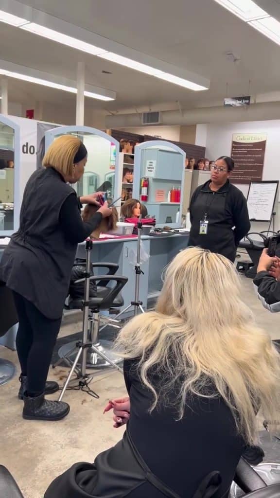 Instructor showing how to cut hair